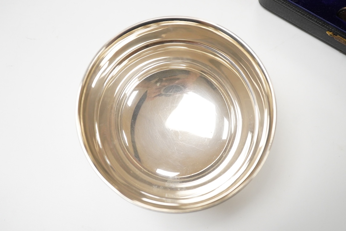 A George VI silver sugar bowl, Viners Ltd, Sheffield, 1946, diameter 10.9cm, together with a cased silver spoon & pusher and a silver mounted glass liquor jug.